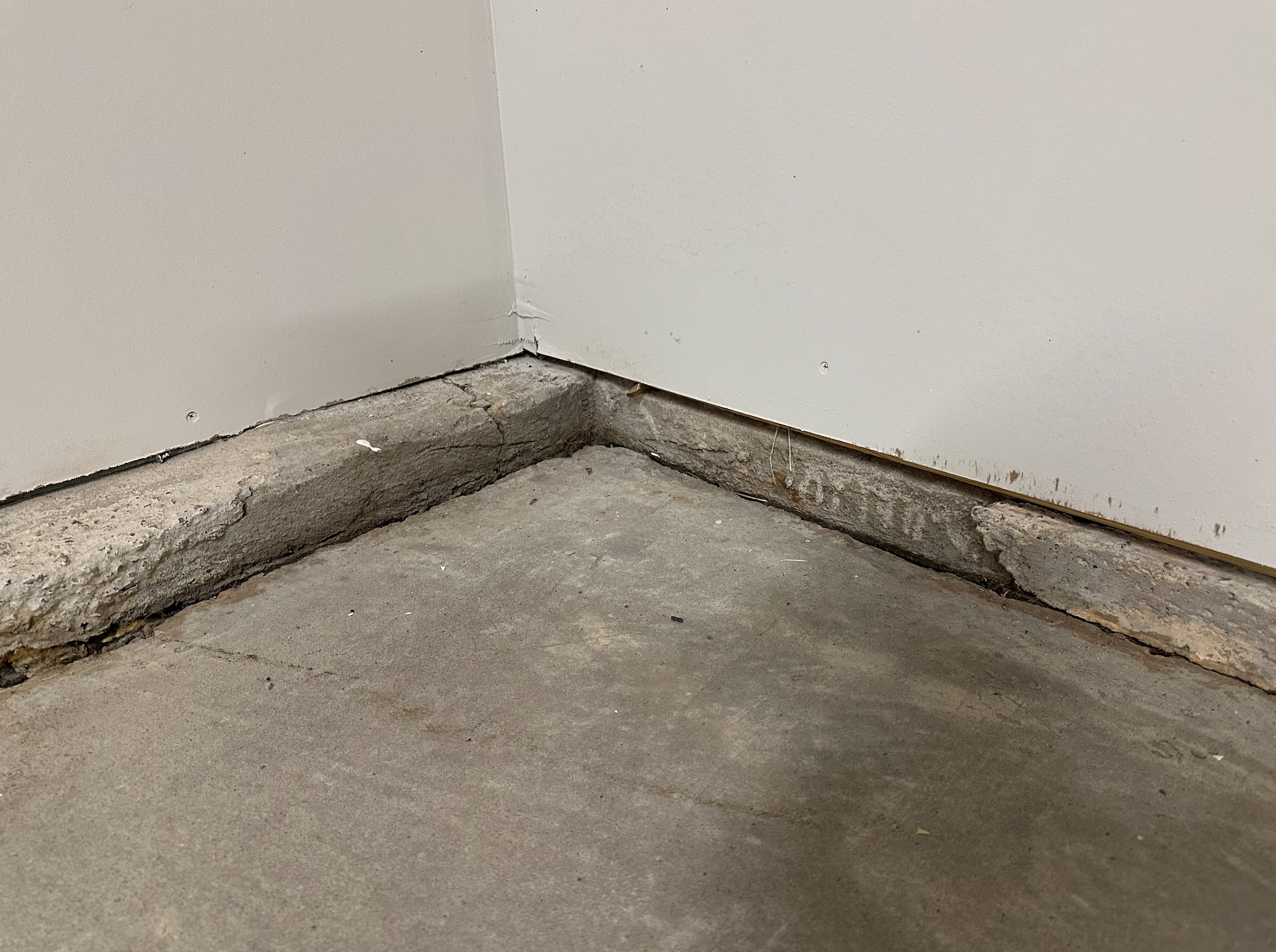 Rotted floor joist in a crawl space showing wood decay and moisture damage